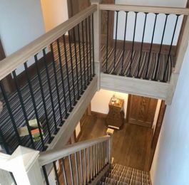 Staircase - sold oak handrail, baserail and knewl posts, with cast iron spindles: Click Here To View Larger Image